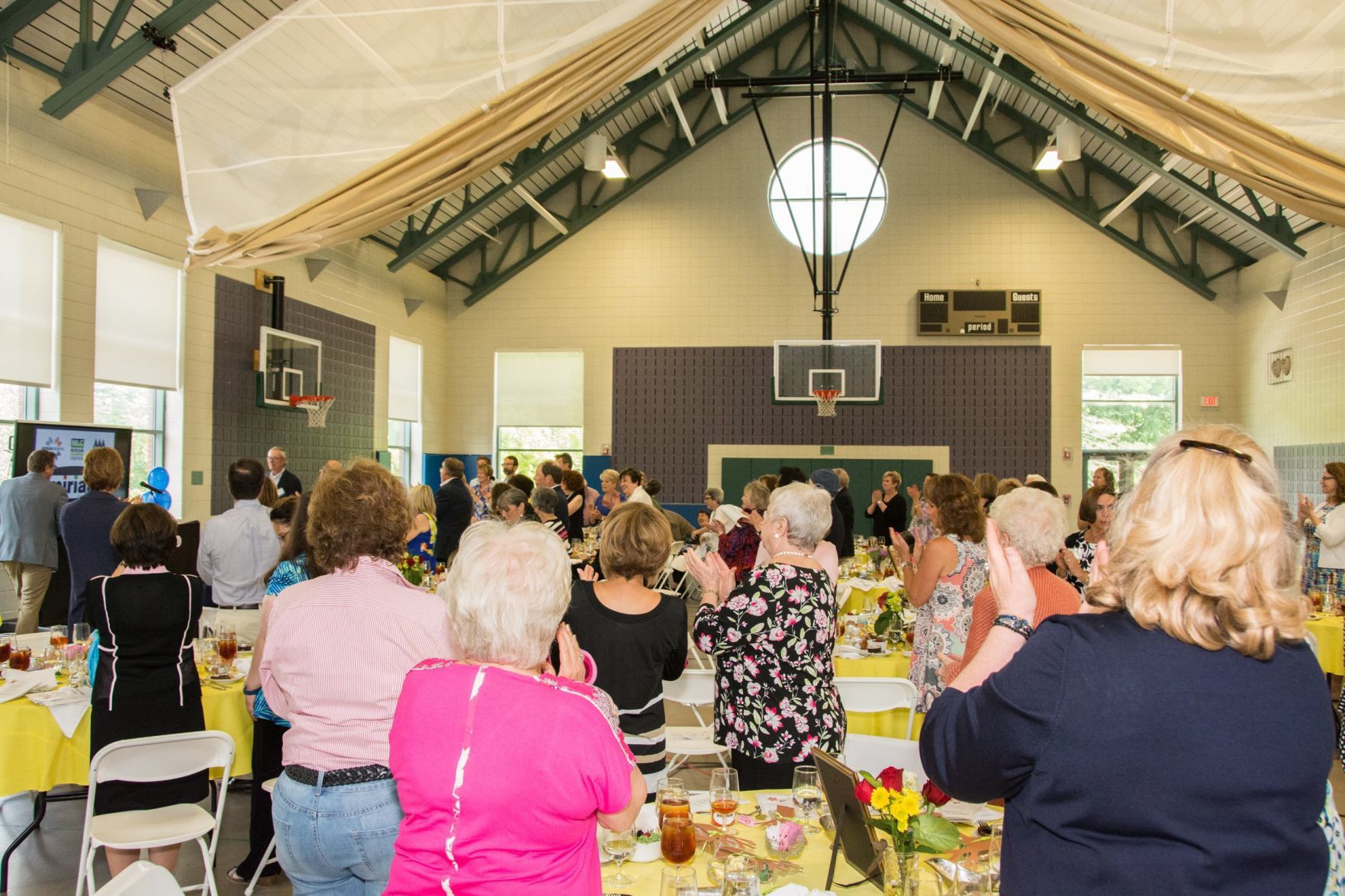 Attendees of the event give a standing ovation for Harry Witte as he approaches the podium at the Friends of Miriam Luncheon